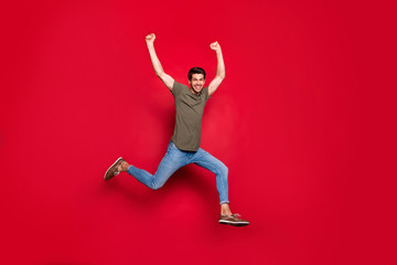 Full size photo of champion guy jumping high came first to marathon finish wear casual outfit isolated on red background