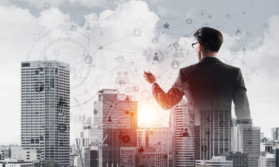 Concept of business success and control with confident boss against cityscape background