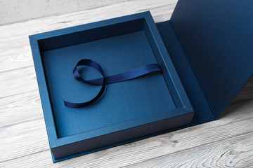stylish square cardboard box for a photo album. open blue cardboard box for a photo book Open box...