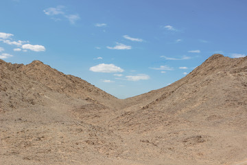 desert rocky hills empty wasteland country side scenery landscape photography in clear weather time and blue sky white clouds background 