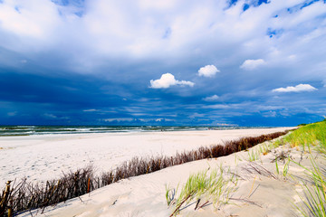 Sandy seaside beach and cloudy sky over the Baltic Sea