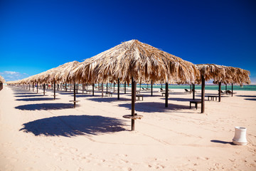 empty clean beach with umbrellas
