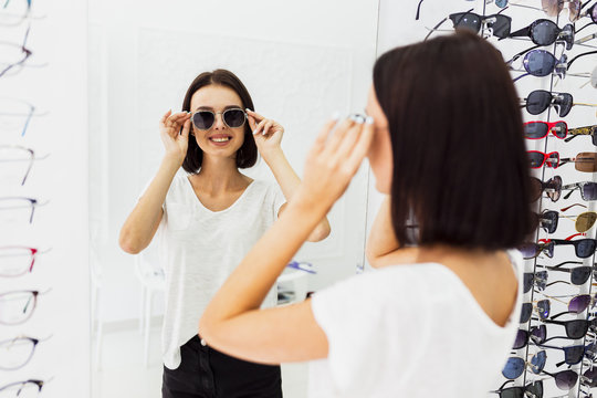 Back View Of Woman Trying Sunglasses