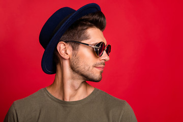 Profile photo of amazing guy wear vintage hat sun specs and grey t-shirt isolated on red background