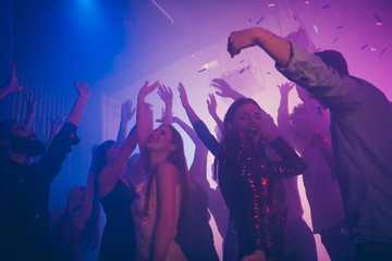 Low angle view of company glad positive excited guys having fun time weekend hanging out event celebratory festive rising hands up at new cool modern bar place indoors © deagreez