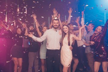 Portrait of charming fellows feel content hugging embracing dance floor discotheque