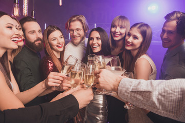 Portrait of nice chic lovely adorable glamorous fascinating luxury attractive fashionable gorgeous cheerful glad ladies and guys having fun clinking wineglasses sparkles at fogged lights nightclub