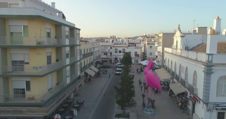 Aerial cityscape of Olhao downtown, view of ancient neighbourhoods traditional cubist architecture and landmark market. Algarve, Portugal.