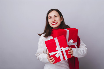 Photo of beautiful woman holding gifts for wonter holidays, free copyspace