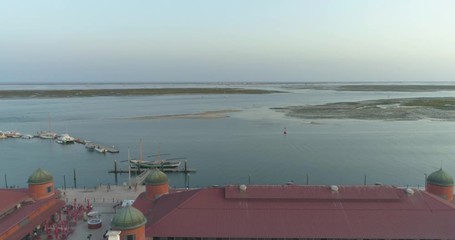 Aerial cityscape of Olhao downtown, view of ancient neighbourhoods traditional cubist architecture and landmark market. Algarve, Portugal.