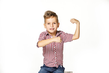 handsome boy shows his strength on white background
