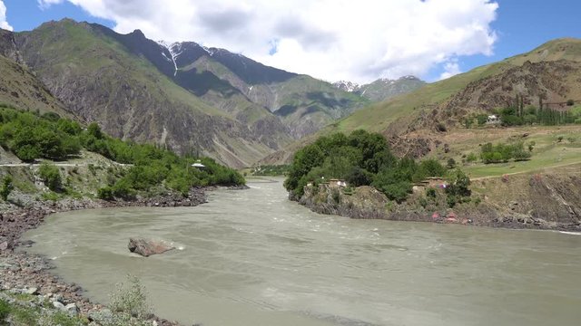 Kulob to Qalai Khumb Pamir Highway along the Panj River with View of a Village on the Afghanistan Side on a Sunny Blue Sky Day