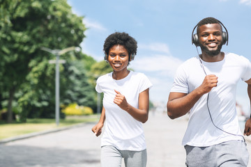 African American Couple Jogging Outdoor In Park