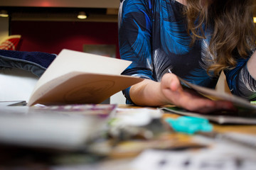 Woman reading a book and studying for school. Girl reading magazine. 