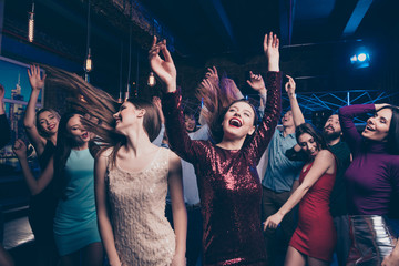 Nice-looking gorgeous attractive glamorous cheerful glad positive stylish girls and guy buddy fellow having fun weekend solemn festal festive fest feast in fashionable luxury place nightclub