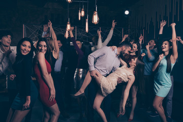 Nice-looking attractive glamorous cheerful cheery positive elegant stylish ladies and gentlemen having fun weekend tango in modern fashionable luxurious nightclub indoors