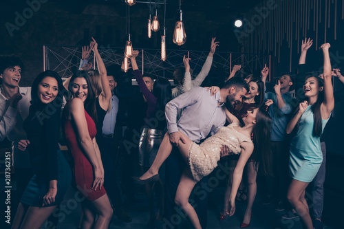 Nice-looking attractive glamorous cheerful cheery positive elegant stylish ladies and gentlemen having fun weekend tango in modern fashionable luxurious nightclub indoors