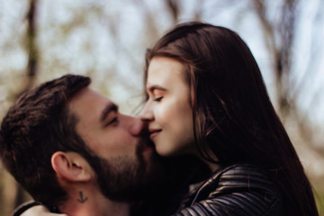 Fototapeta premium Head shot of young affectionate romantic couple in love. Close up portrait of attractive brunette girl and guy with eyes closed, close to each other. Concept of first kiss, tenderness and amorousness