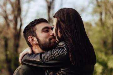 Head shot of young affectionate romantic couple in love. Close up portrait of attractive brunette girl and guy with eyes closed, close to each other. Concept of first kiss, tenderness and amorousness