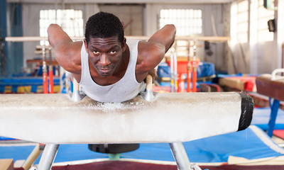 African man training at gymnastic hall