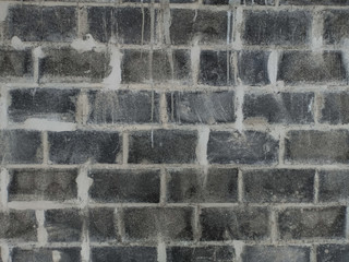 The brick wall has just been finished with cement and has not been smoothed. Construction material texture.