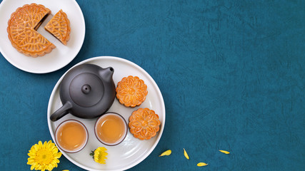 Minimal simplicity layout moon cakes on blue background for Mid-Autumn Festival, creative food design concept, top view, flat lay, copy space.