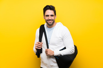 Young sport man over isolated yellow wall