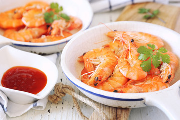 Two portions of fried shrimp and spicy red sauce