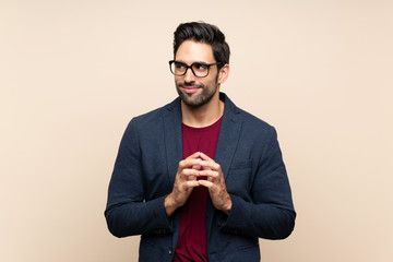 Handsome young man over isolated background scheming something