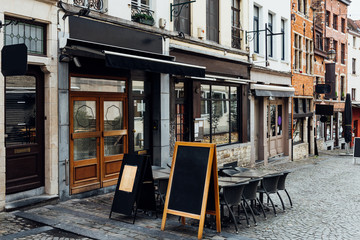 Old street with tables of cafe in center of Brussels, Belgium. Cozy cityscape of Brussels...