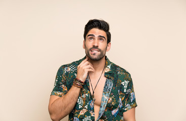 Fototapeta premium Handsome man in summer shirt over isolated background thinking an idea