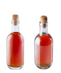 Bottle with red liquid, apple cider vinegar with cork from cork. Isolate on a white background. The photo.