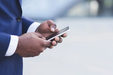 Afro Businessman Hands Using Smartphone In City, Closeup