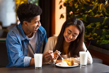 Fototapeta na wymiar Two teenagers in love spending time in cafe