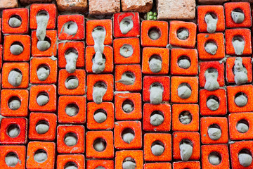 Orange ceramic wall. Pattern of construction material texture.