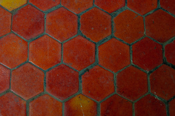 Orange hexagon ceramic tile. Pattern of construction material texture.