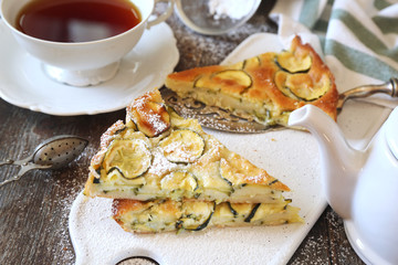 Sweet scarpaccia, Italian cuisine. Thin zucchini sweet pie and cup of tea
