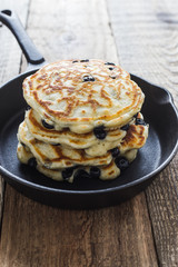 Blueberry  pancakes in cast iron skillet, fresh summer dessert