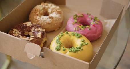 Delicious sweet colorful donuts in takeaway box