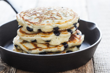 Blueberry  pancakes in cast iron skillet, fresh summer dessert
