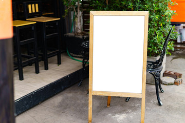 The white blank sheet is placed on located in front of a coffee shop.