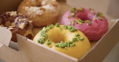 Delicious sweet colorful donuts in takeaway box