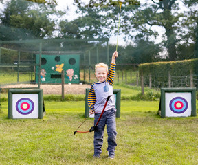 young boy celebrating archery