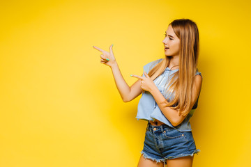 Young blonde woman over isolated yellow wall have an idea and posing. Copy space.