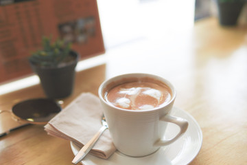 Hot coffee, latte make heart art with a tree in a small pot . Breakfast at a coffee shop