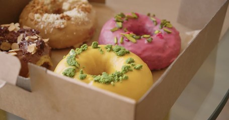 Delicious sweet colorful donuts in takeaway box
