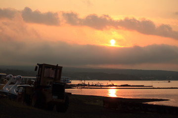 Fototapeta na wymiar Sunset at lake with tractor