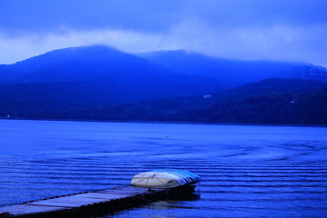 Beautiful landscape with boat, lake and mountains