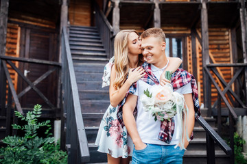 Resting together. Blonde girl and her strong man relaxing on fresh air in the mountains.