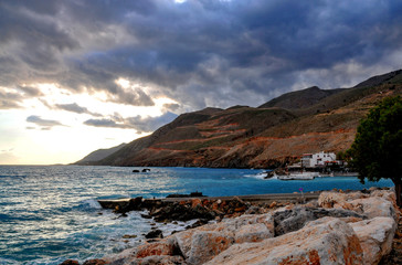 Fototapeta na wymiar Dark clouds over Hora Sfakion on Crete on a evening summers' day